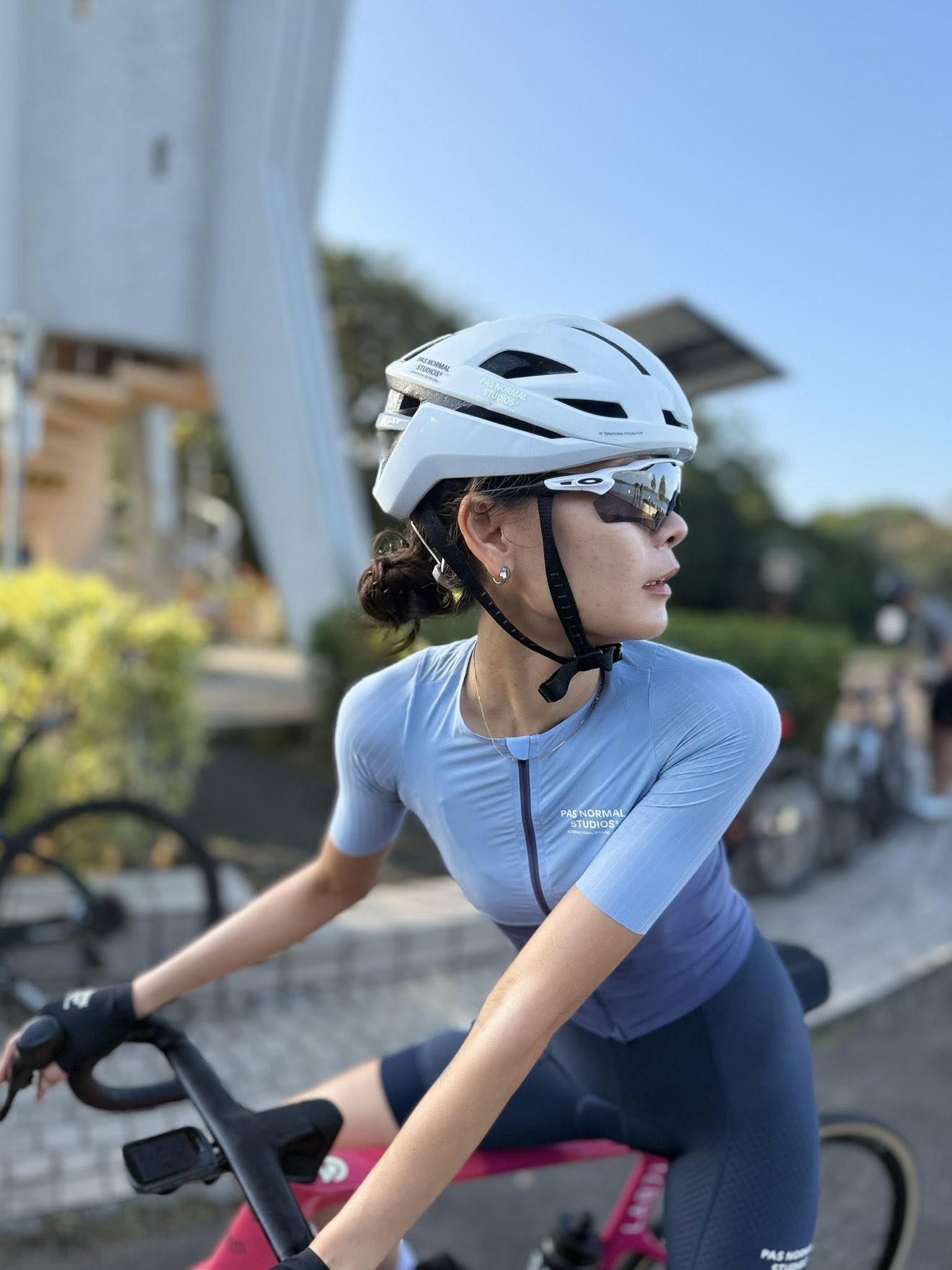 Diem riding in a blue cycling kit and white helmet
