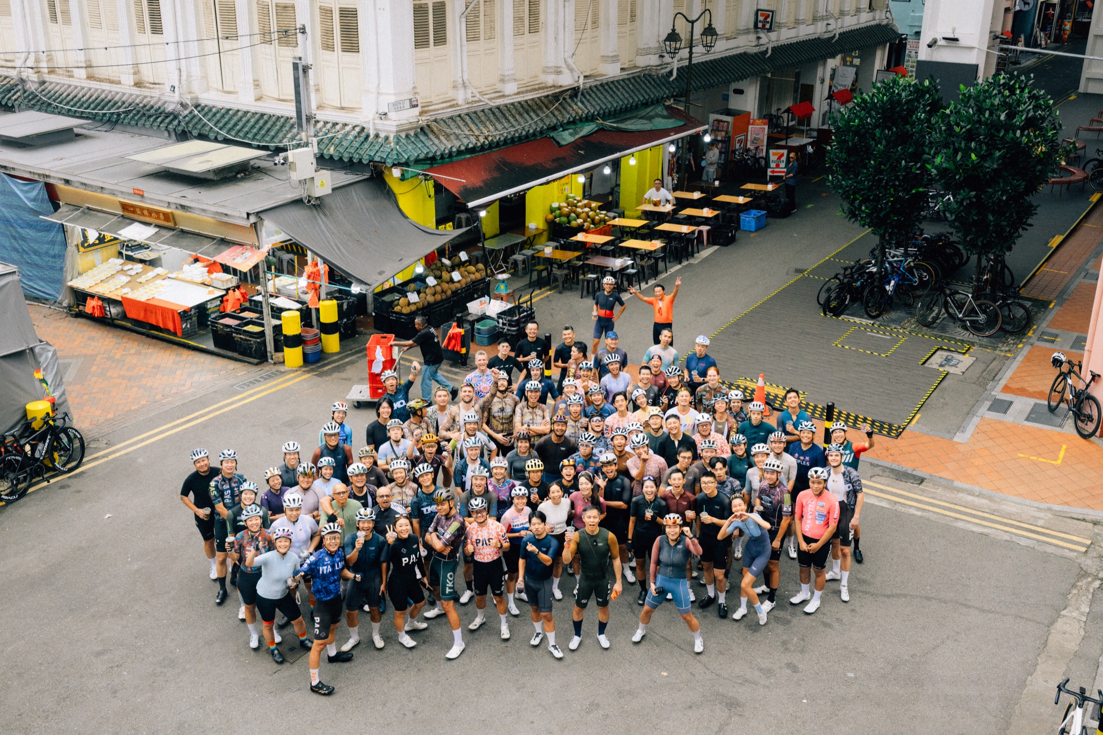 A large cycling community gathered for a colorful group portrait