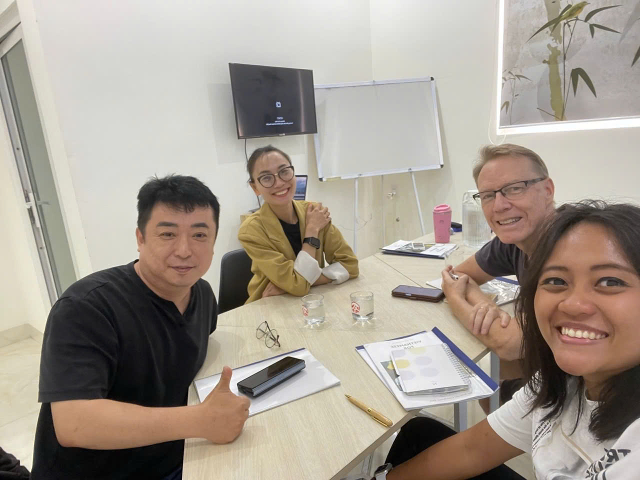 A corporate Vietnamese class gathered around a table